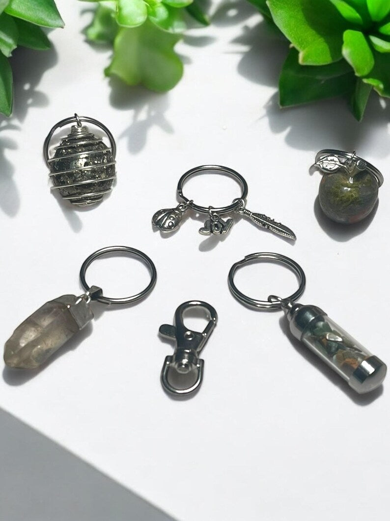 Grounding & Abundance Crystal Keychain Set – Pyrite Spiral, Smoky Quartz Point, Unakite Apple, Mini Gem Jar & Lucky Charms