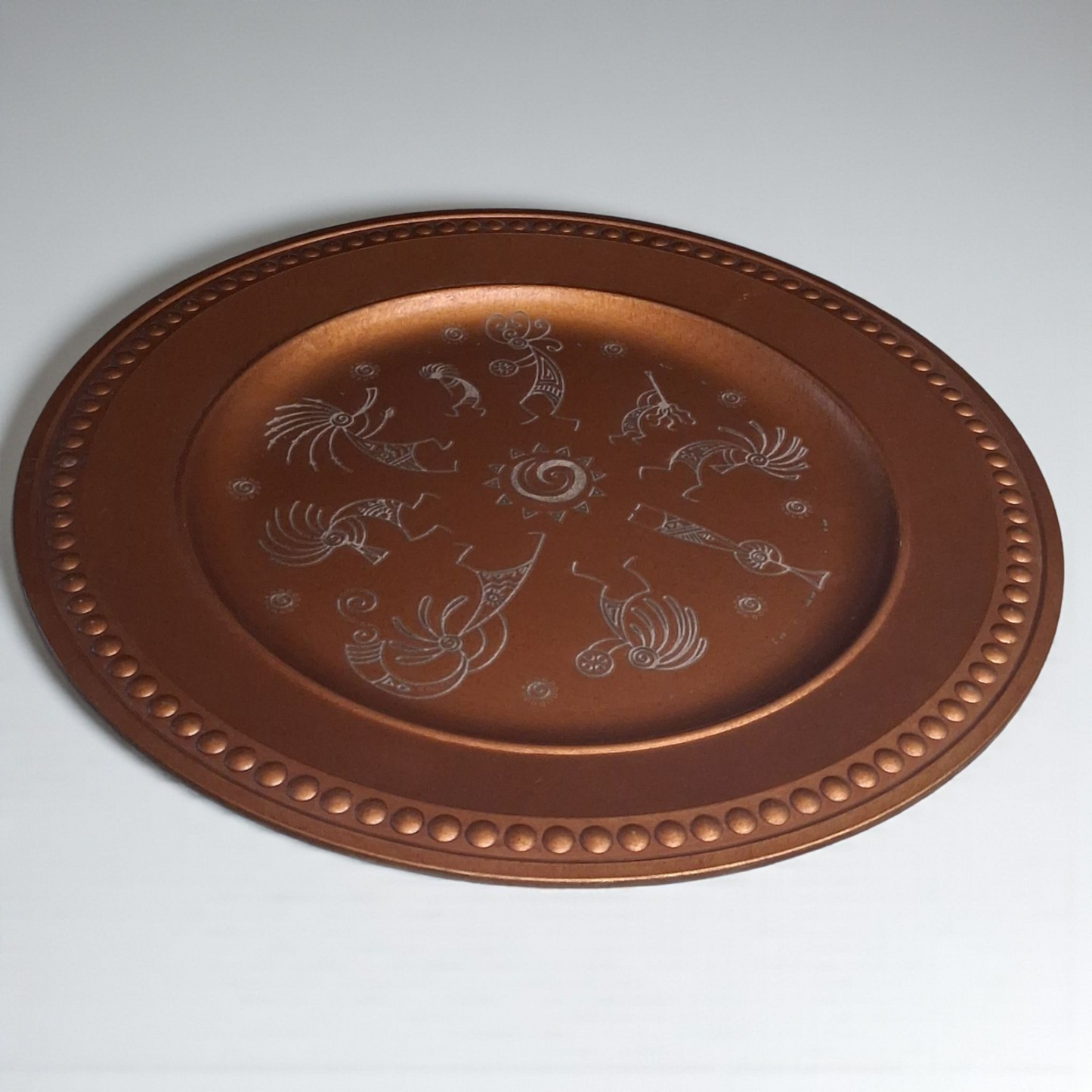 Engraved Copper-Tone Plate – 12" Round Decorative Tray with Tribal Sun & Dancer Design