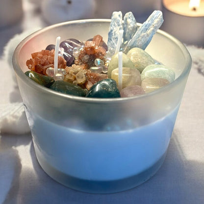 JoyfulBliss Co. 18oz soy ritual candle topped with healing crystals like amethyst, blue kyanite, and quartz in a glass jar.