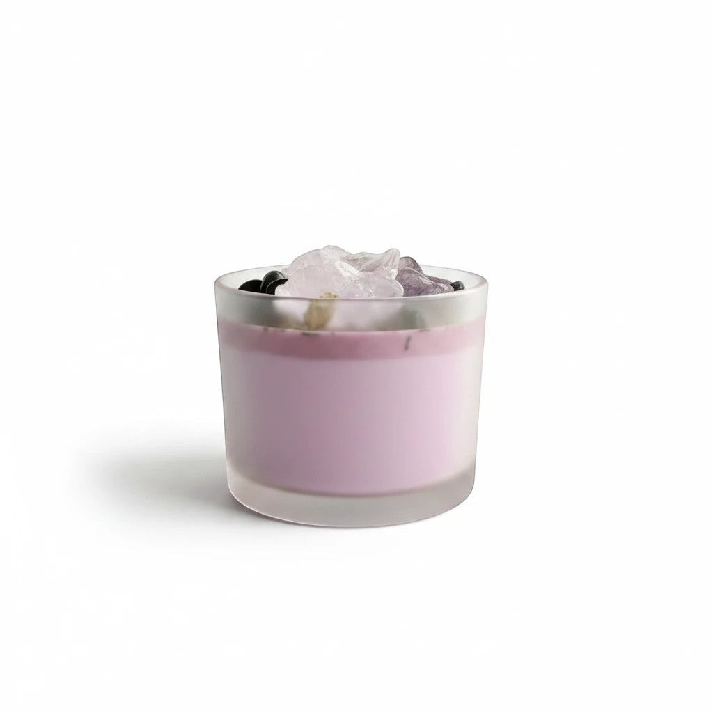 JoyfulBliss Co. Protect + Deflect soy candle in a frosted glass jar topped with protective crystals and herbs.