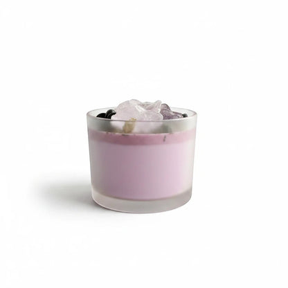 JoyfulBliss Co. Protect + Deflect soy candle in a frosted glass jar topped with protective crystals and herbs.