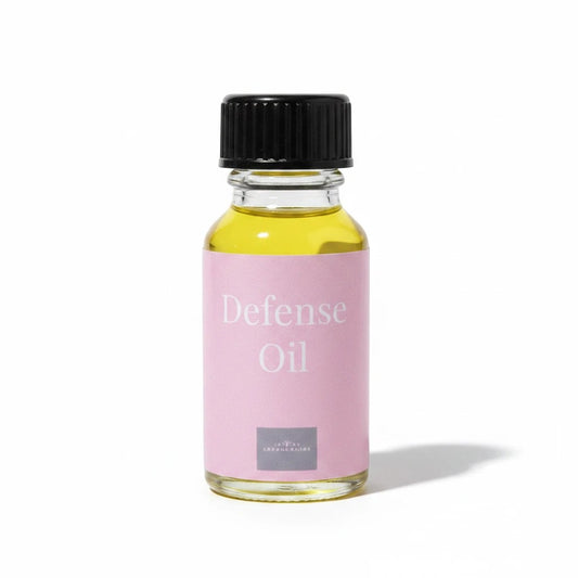 JoyfulBliss Co. Defense Ritual Anointing Oil in a 10ml glass bottle with a pink label and black cap