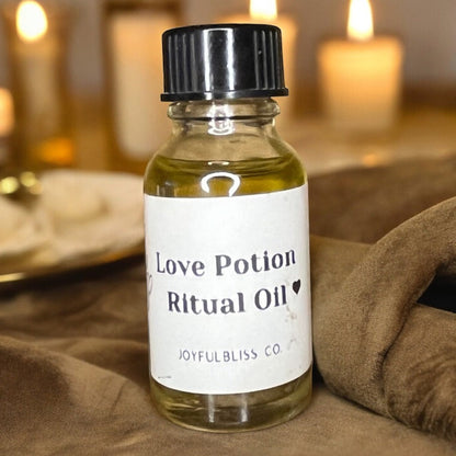 JoyfulBliss Co. Love Potion Ritual Anointing Oil in a 10ml glass bottle with a black cap on a brown velvet cloth.