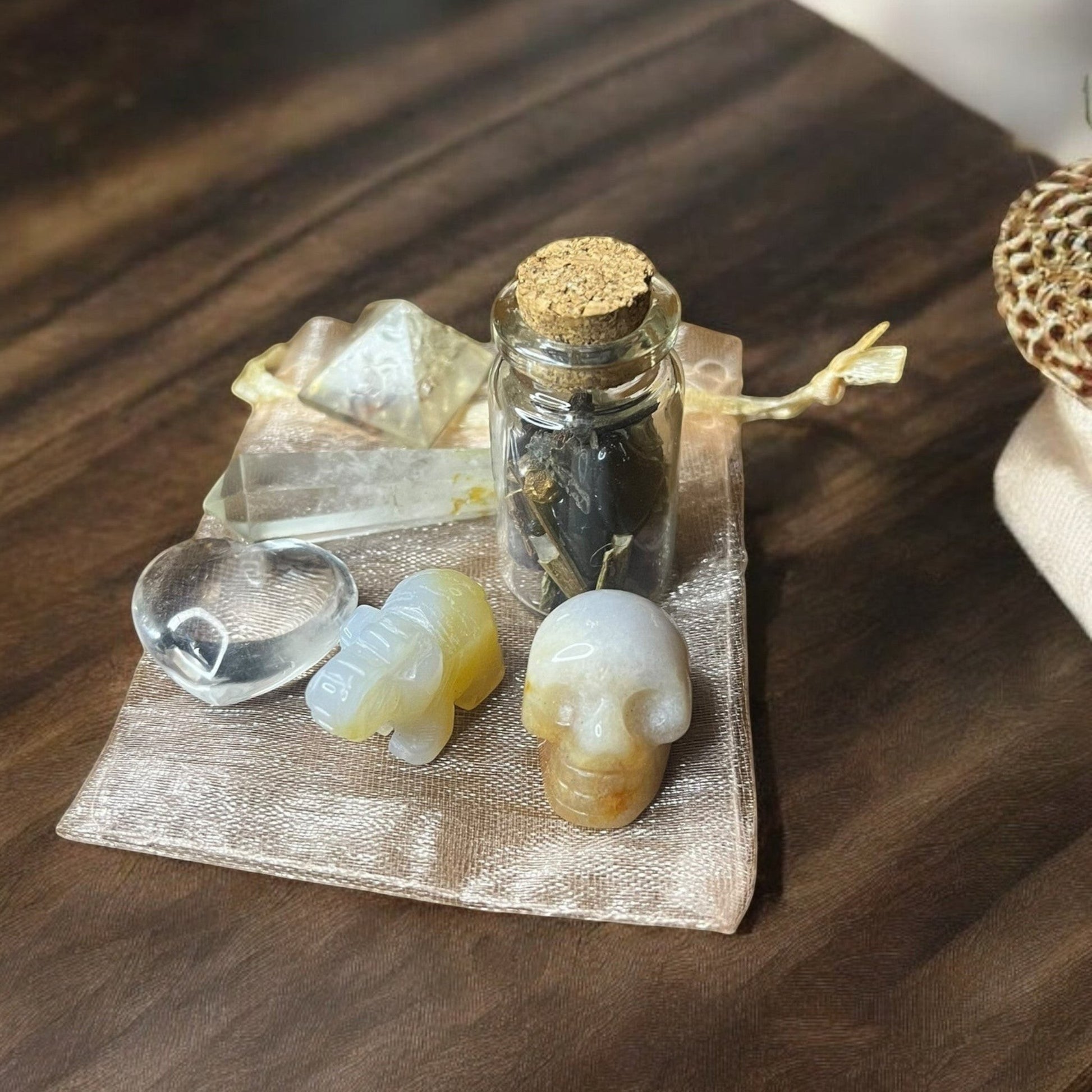 JoyfulBliss Co. Manifesting Mojo Bag with crystals, spell jar, and organza pouch for spiritual intention setting.