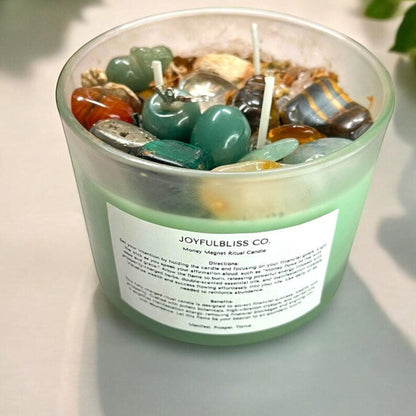JoyfulBliss Co. Money Magnet ritual candle in a frosted glass jar, topped with crystals, botanicals, and triple wicks.