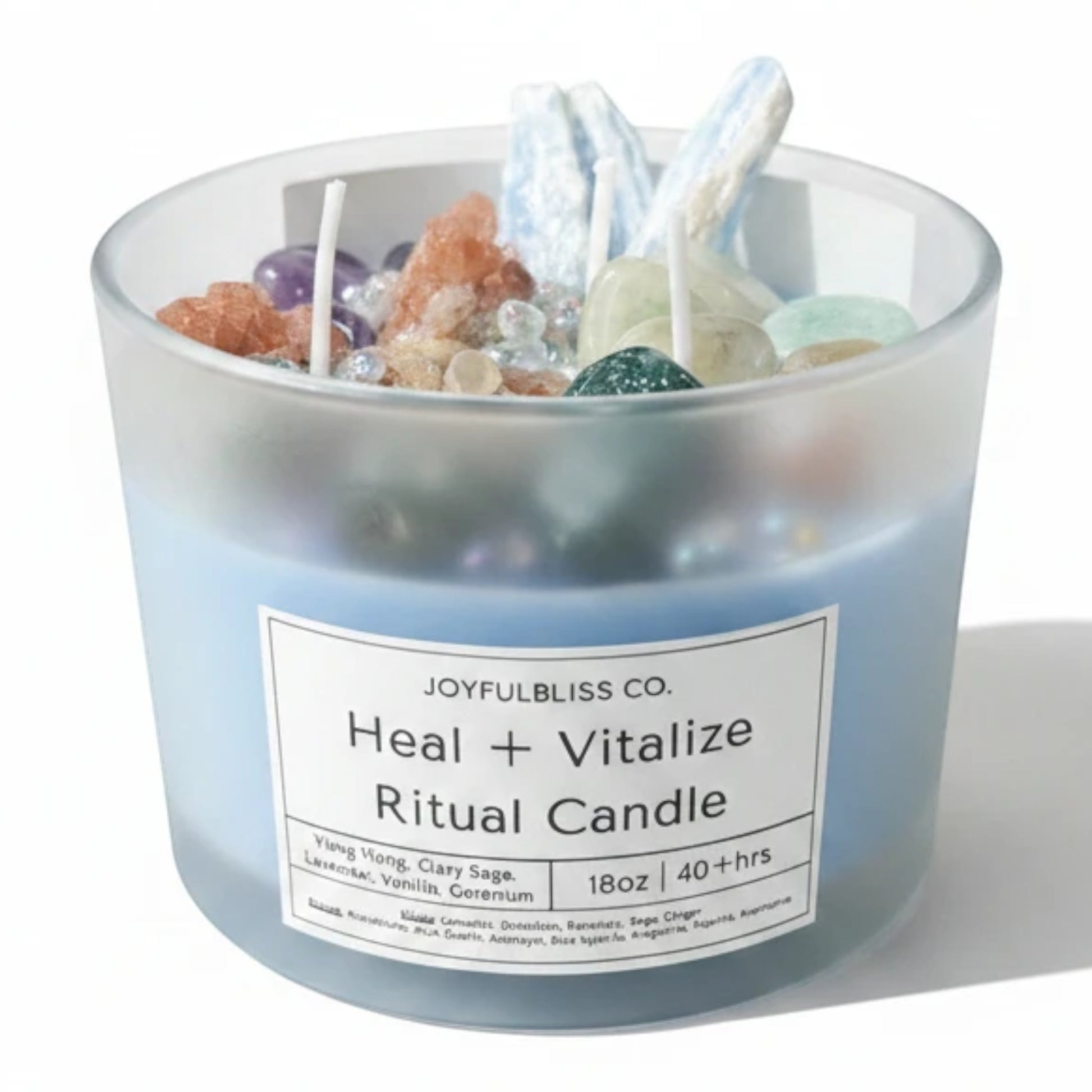 JoyfulBliss Co. 18oz Heal + Vitalize ritual candle in a frosted blue glass jar topped with healing crystals and herbs.