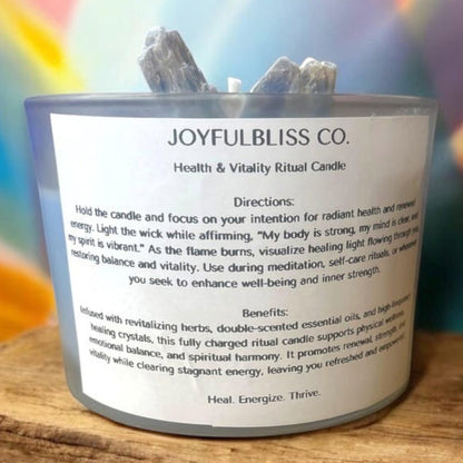 JoyfulBliss Co. Heal + Vitalize ritual soy candle in a glass jar topped with healing crystals on a wooden surface.