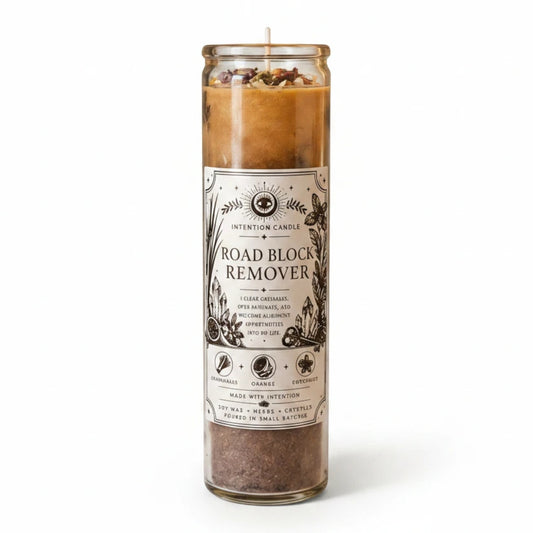 JoyfulBliss Co. Road Block Remover soy wax intention candle with herbs and crystals in a glass jar.