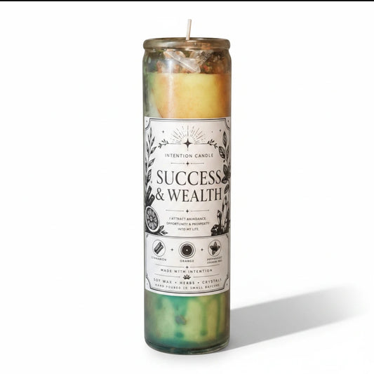 JoyfulBliss Co. Success & Wealth intention candle in a tall glass jar with soy wax, herbs, and crystals.