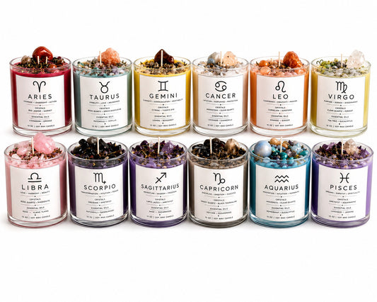 JoyfulBliss Co. set of 12 zodiac soy wax candles in glass jars topped with crystals, herbs, and essential oils.